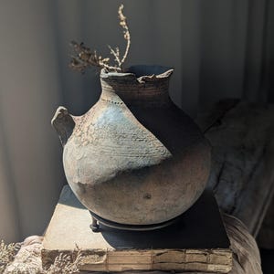 Vintage bottle neck clay vessel with stand