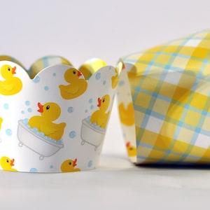 May include: Yellow and blue cupcake liners with a checkered pattern and a pattern of rubber ducks in a bathtub.