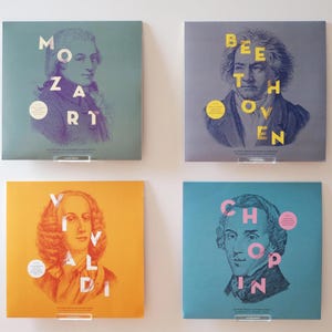 May include: Four vinyl record covers featuring portraits of famous composers. The covers are blue, grey, orange, and teal. The composers' names are printed in large, bold letters on each cover: Mozart, Beethoven, Vivaldi, and Chopin.