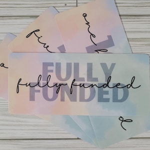 May include: A set of five pastel-colored cards with the words "one", "two", "three", "four", and "five" written on them. The cards are stacked on top of each other, with the top card showing the words "fully funded" in a bold, gray font.