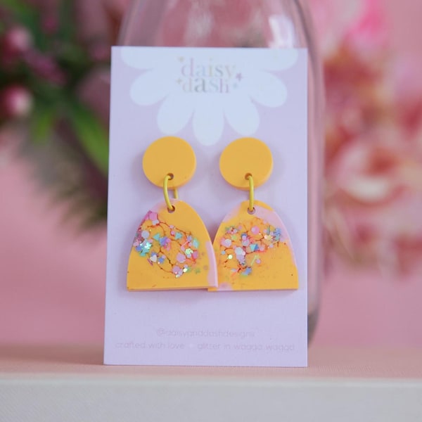 cute arch yellow and pink with a touch of glitter dangle earrings, small statement dangles in bright colours party festival earrings
