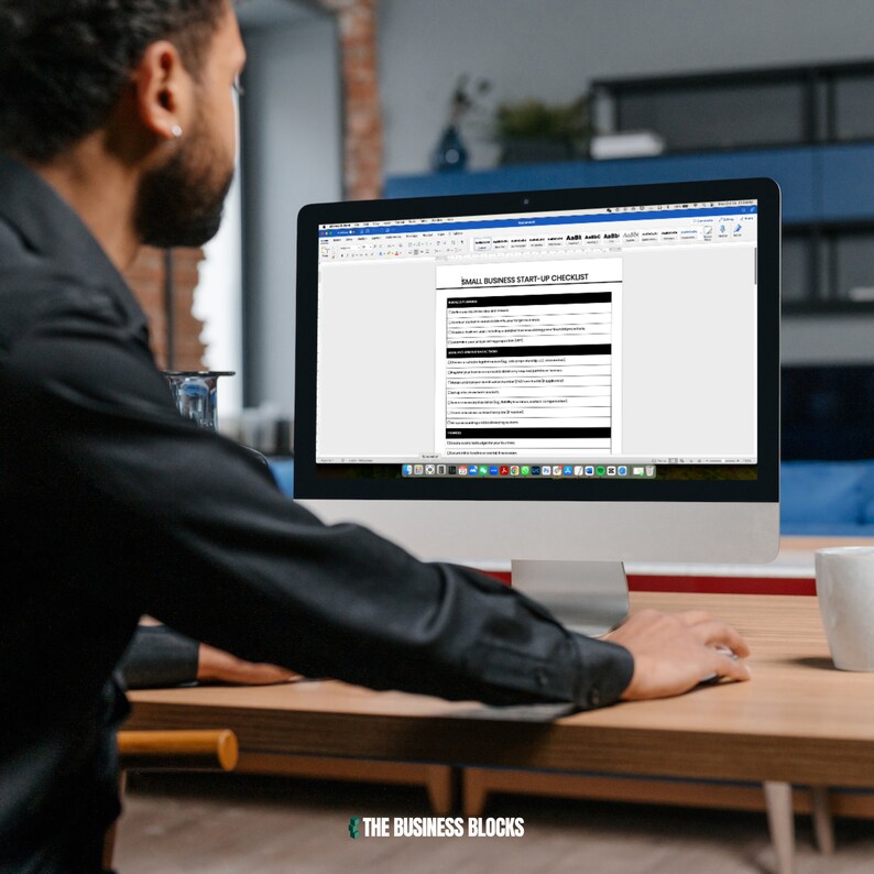 May include: A person is looking at a computer screen displaying a checklist titled "Small Business Start-Up Checklist". The checklist includes a list of items to consider when starting a business.