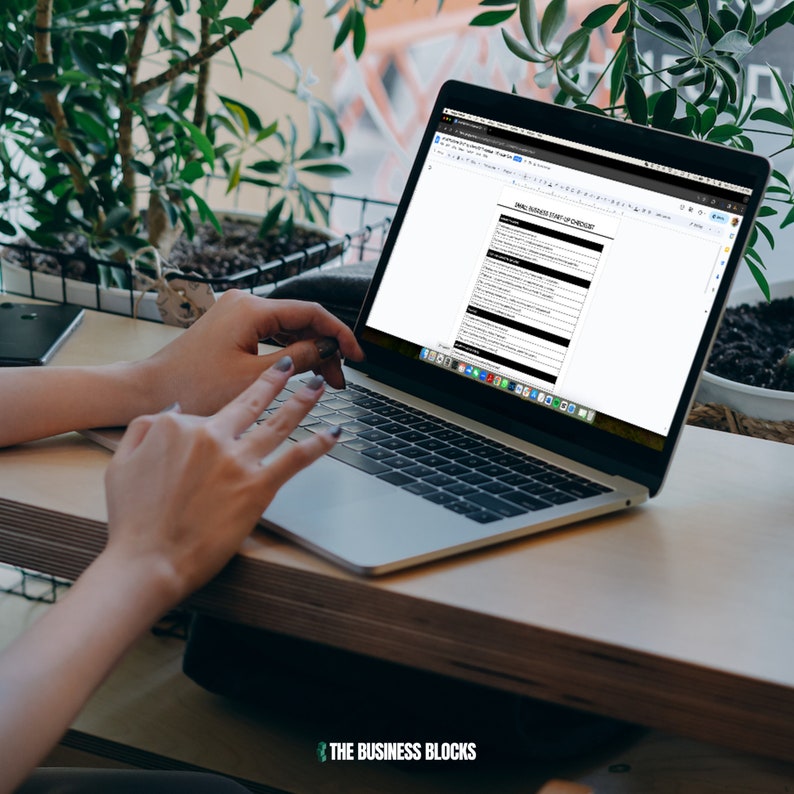 May include: A person working on a laptop computer with a white background. The laptop screen displays a checklist titled "Small Business Start Up Checklist".