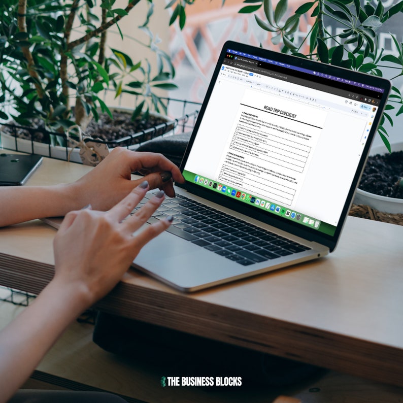 May include: A person is using a laptop computer to view a checklist titled "Road Trip Checklist". The checklist is divided into sections with checkboxes and text fields for planning a road trip.