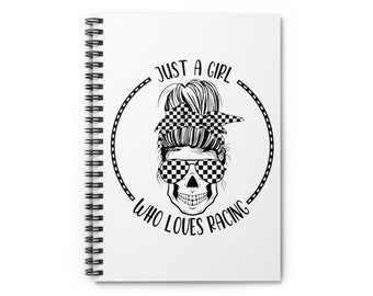 May include: A white spiral notebook with a black and white illustration of a skull wearing checkered sunglasses and a checkered hair bow. The text "Just a girl who loves racing" is written in a circle around the skull.