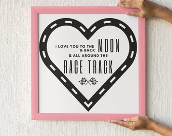 May include: A pink framed print with a black and white graphic of a heart-shaped race track with the text "I love you to the moon & back & all around the race track".