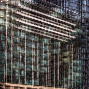 May include: An abstract architectural photograph of a modern building with a glass facade. The building has multiple stories with horizontal white bands and vertical lines. The color palette includes shades of blue, green, and brown.
