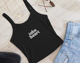 May include: Black tank top with a white graphic that says "take heart".