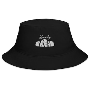 May include: Black bucket hat with white embroidery that reads "Daily Bread".