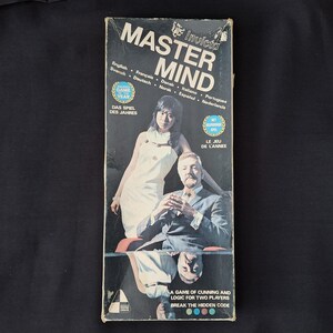 May include: Vintage Invicta Master Mind game box. The box features the game title in large white letters, with images of a man and woman. Text includes "A game of cunning and logic for two players."