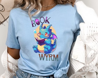 May include: A light blue t-shirt with a cartoon dragon wearing glasses and reading a book. The text "BOOK WORM" is printed on the shirt.