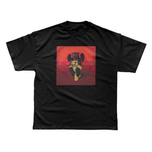 a black t - shirt with a picture of a bear on it