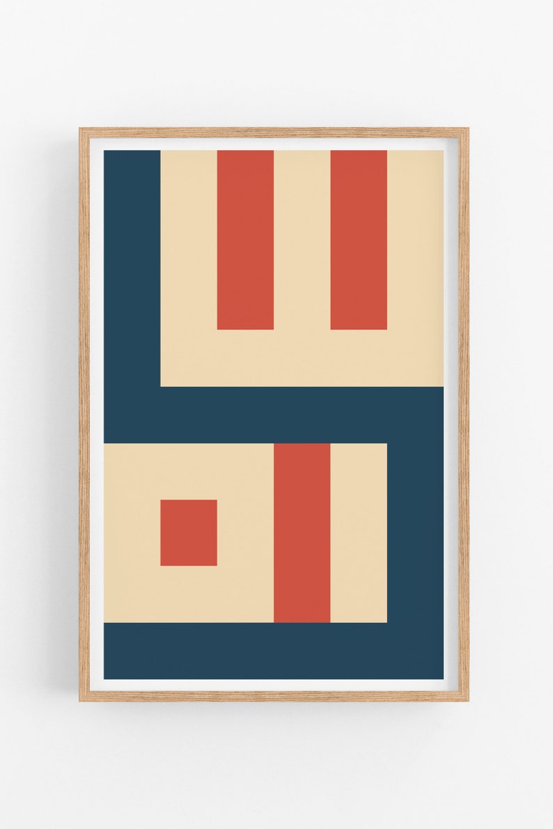 May include: Abstract geometric art print with a beige background, red and dark blue shapes. The print is framed in a light wood frame.