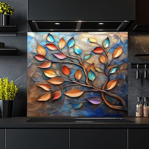 Pode incluir: Uma impressão de arte abstrata colorida de uma árvore com folhas em tons de azul, verde, laranja, vermelho e amarelo. As folhas são estilizadas e parecem ser feitas de metal. O fundo é azul e marrom texturizado.