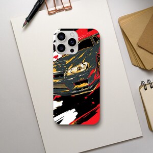 May include: A phone case featuring a stylized illustration of a gray sports car with yellow and red accents. The design has a dynamic, artistic feel with bold brushstrokes against a white, red, and black background.