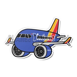 Puede incluir: Un avión de dibujos animados azul y blanco con la palabra "Southwest" en el lateral. El avión tiene una cola roja, amarilla y naranja.
