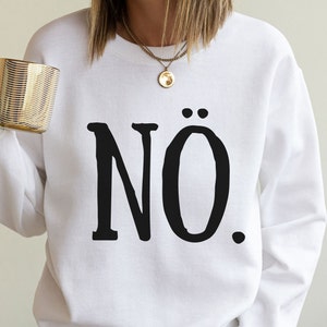 May include: White sweatshirt with black text that says "N&Ouml;."