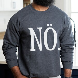 May include: A dark gray sweatshirt with the word "N&Ouml;." printed in white on the front.