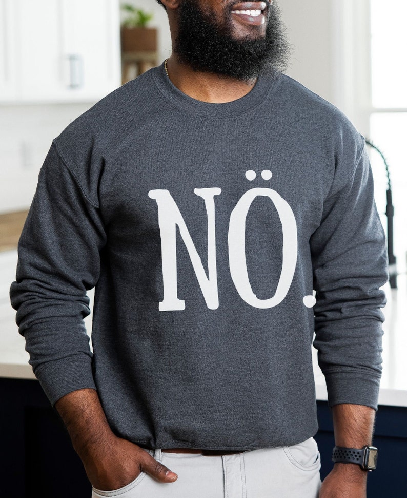May include: A dark gray sweatshirt with the word "N&Ouml;." printed in white on the front.