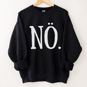 May include: Black sweatshirt with the word "N&Ouml;." printed in white on the front.