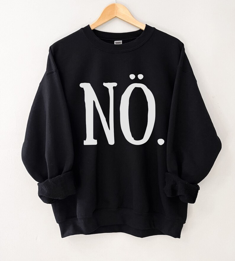 May include: Black sweatshirt with the word "N&Ouml;." printed in white on the front.