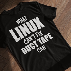 May include: Black t-shirt with white text that reads "What Linux can't fix duct tape can."