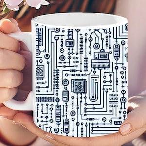 May include: White ceramic mug with a black and white circuit board design. The mug is being held by a person's hands.
