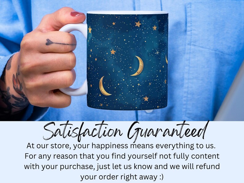 May include: A white ceramic mug with a blue and gold design featuring a crescent moon and stars. The mug has a handle and is held by a hand. The text "Satisfaction Guaranteed" is displayed below the mug.