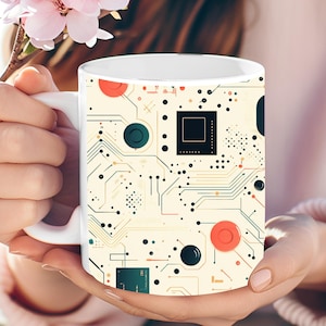 May include: White ceramic mug with a circuit board design. The design features a yellow, orange, red, blue, and black color scheme.