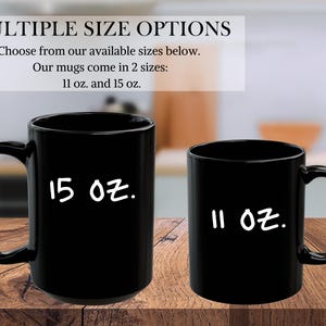May include: Two black coffee mugs, one 11 ounce and one 15 ounce, on a wooden surface. The mugs are both black with white text.