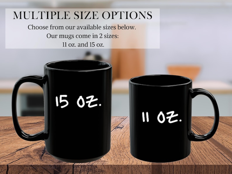 May include: Two black coffee mugs, one 11 ounce and one 15 ounce, on a wooden surface. The mugs are both black with white text.
