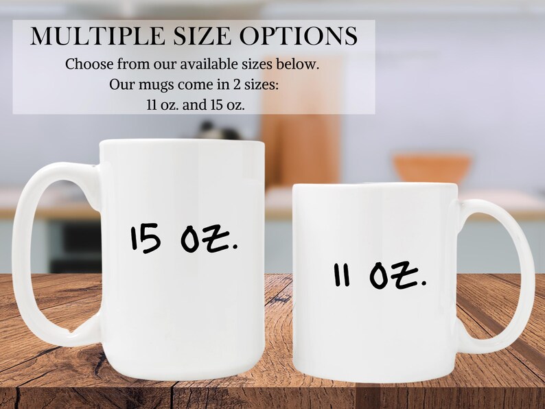 May include: Two white ceramic mugs with black handwritten text. The larger mug says "15 oz." and the smaller mug says "11 oz."