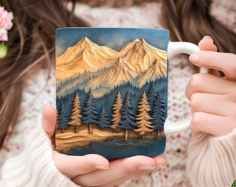 May include: A white ceramic mug with a mountain scene design. The mug features a detailed illustration of a mountain range with a forest in the foreground. The mountains are depicted in shades of brown and yellow, while the forest is a deep blue.