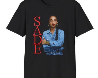 May include: Black t-shirt with a red "SADE" graphic and a photo of Sade in a blue denim shirt and jeans.