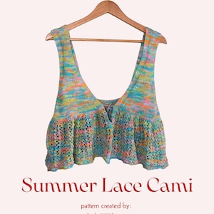 May include: A colorful, hand-knitted Summer Lace Cami hangs on a wooden hanger. The cami features a scoop neck and a ruffled hem. The text "Summer Lace Cami" is displayed below the cami, with the designer's name, "lucky777loops," underneath.