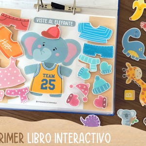 May include: An interactive children's book with an elephant character and various clothing items. The book includes a basketball jersey with the number 25, hats, scarves, and other accessories. Additional animal-shaped stickers are also included.