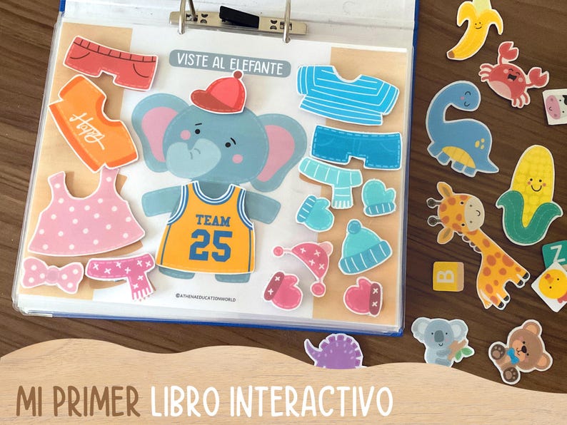 May include: An interactive children's book with an elephant character and various clothing items. The book includes a basketball jersey with the number 25, hats, scarves, and other accessories. Additional animal-shaped stickers are also included.