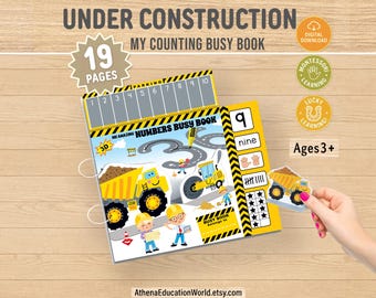 Könnte beinhalten: Ein farbenfrohes Kinder-Zähl-Beschäftigungsbuch mit einem Konstruktionsthema. Das Buch enthält Illustrationen von Baufahrzeugen, Zahlen und den Text "UNDER CONSTRUCTION" und "MY COUNTING BUSY BOOK". Enthält ein "DIGITAL DOWNLOAD"-Abzeichen und ist für Kinder ab 3 Jahren geeignet.