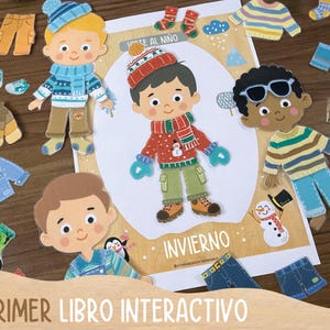 May include: An interactive children's book with paper dolls and winter clothing cutouts. The cover features the text "MI PRIMER LIBRO INTERACTIVO" and the word "INVIERNO". The paper dolls are dressed in winter clothes, including hats, scarves, and mittens.