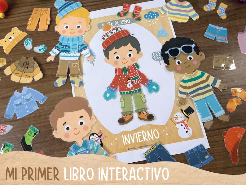 May include: An interactive children's book with paper dolls and winter clothing cutouts. The cover features the text "MI PRIMER LIBRO INTERACTIVO" and the word "INVIERNO". The paper dolls are dressed in winter clothes, including hats, scarves, and mittens.