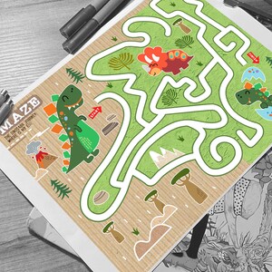 May include: A green dinosaur maze with a brown, textured background. The maze has a start and finish point. The dinosaur is green with orange spikes and is holding a red egg. The maze is surrounded by trees, rocks, and a volcano.