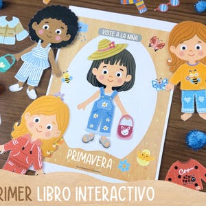 May include: A children's interactive book with paper dolls and clothing cutouts. The book features illustrations of girls and the text "Viste a la Ni&ntilde;a" and "Primavera". Clothing cutouts include a jacket, pants, socks, and a purse.