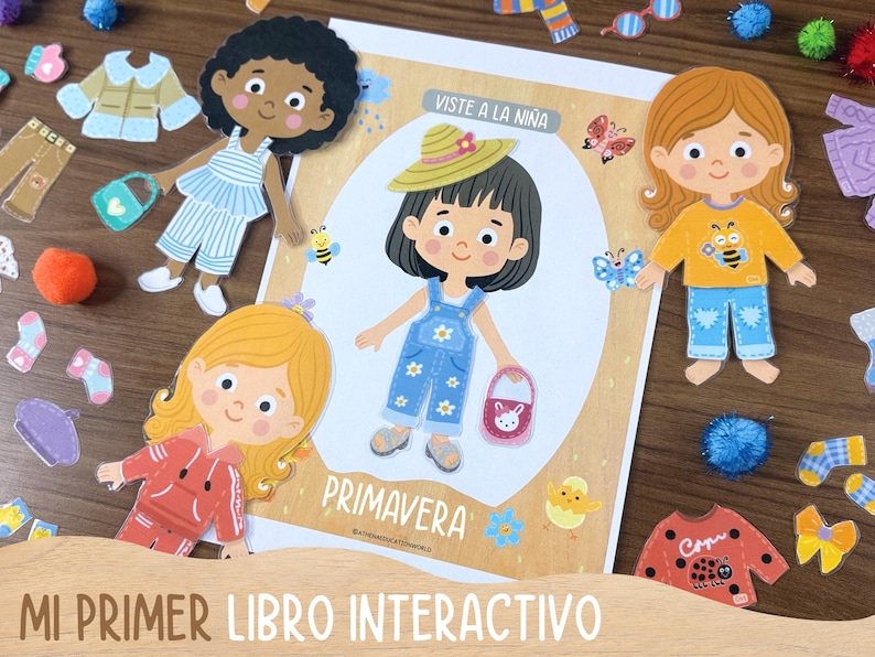 May include: A children's interactive book with paper dolls and clothing cutouts. The book features illustrations of girls and the text "Viste a la Ni&ntilde;a" and "Primavera". Clothing cutouts include a jacket, pants, socks, and a purse.