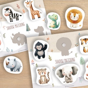 Puede incluir: Un juego educativo para ni&ntilde;os con piezas de rompecabezas con forma de animales y sombras coincidentes. El juego incluye ilustraciones de una cebra, una jirafa, un le&oacute;n, un tigre y otros animales de safari. El texto "SHADOW MATCHING" est&aacute; impreso.