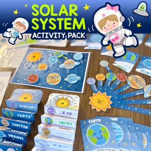 May include: A colourful solar system activity pack with the text "SOLAR SYSTEM ACTIVITY PACK". The pack includes planet cards, a solar system map, and planet-themed boxes. The illustrations feature smiling planets and astronauts.