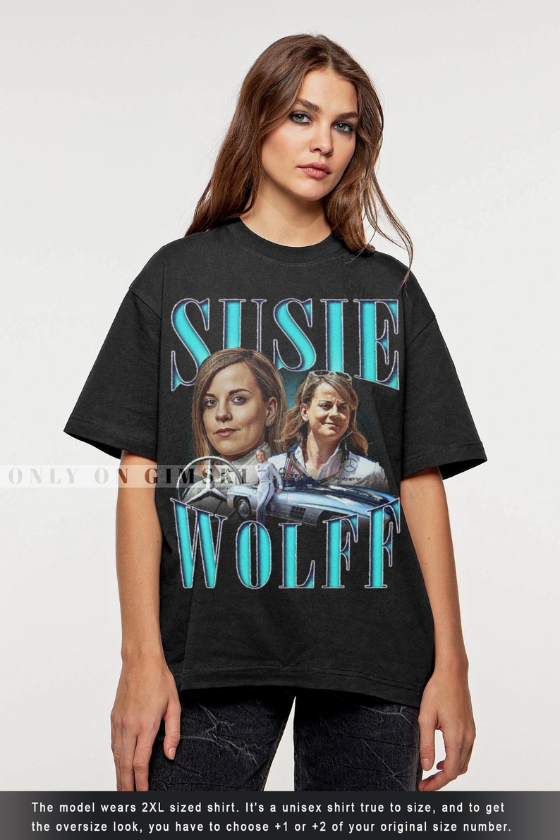 May include: Black t-shirt with a vintage-style graphic of Susie Wolff, a race car driver, with the text "Susie Wolff" in a blue and white font.