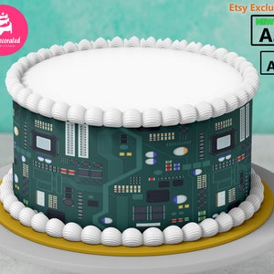 May include: A white cake with green and black icing depicting a circuit board. The cake is on a white cake stand with a gold trim. The text "Etsy Exclusive" and "NEW" are in the top right corner of the image.