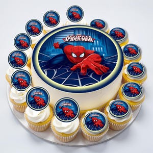 May include: A round cake decorated with a Spiderman image and the words "Marvel's Ultimate Spiderman". The cake is surrounded by 12 cupcakes, each decorated with a smaller Spiderman image.