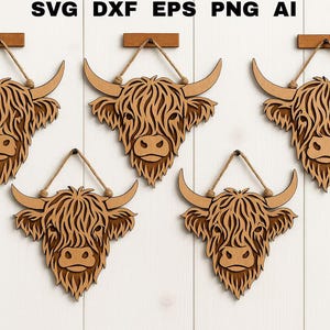 May include: Five wooden Highland cow head wall hangings. Each has a light brown finish, detailed fur, and curved horns. They are suspended by twine from a small wooden bar. The top of the image has the text "SVG DXF EPS PNG AI".