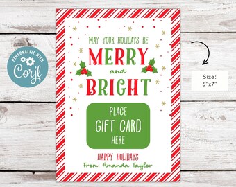 May include: A printable gift card holder with a red and white striped background. The text reads "May your holidays be Merry and Bright". There is a green rectangle with the text "Place Gift Card Here". The text "Happy Holidays" and "From: Amanda Taylor" are also included. The size is 5 inches by 7 inches.